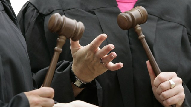 Women pro-choice activists gather in judges' gowns and hold gavels outside the Supreme Court in Washington, DC June 27, 2005. A divided U.S. Supreme Court declared on Monday it was unconstitutional to post framed copies of the Ten Commandments in county courthouses but permissible to have a commandments monument on the grounds of a state Capitol. The two 5-4 rulings on the politically charged issue involving Ten Commandments displays on government property came in a pair of cases that have been widely regarded as the most important of the court term concerning church-state separation. REUTERS/Jason Reed  JIR/CN - RTRFNXL