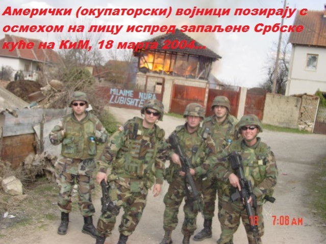 US soldiers from KFOR force smiling while in their background Serbian house goes up in flames KOSOVO 2004